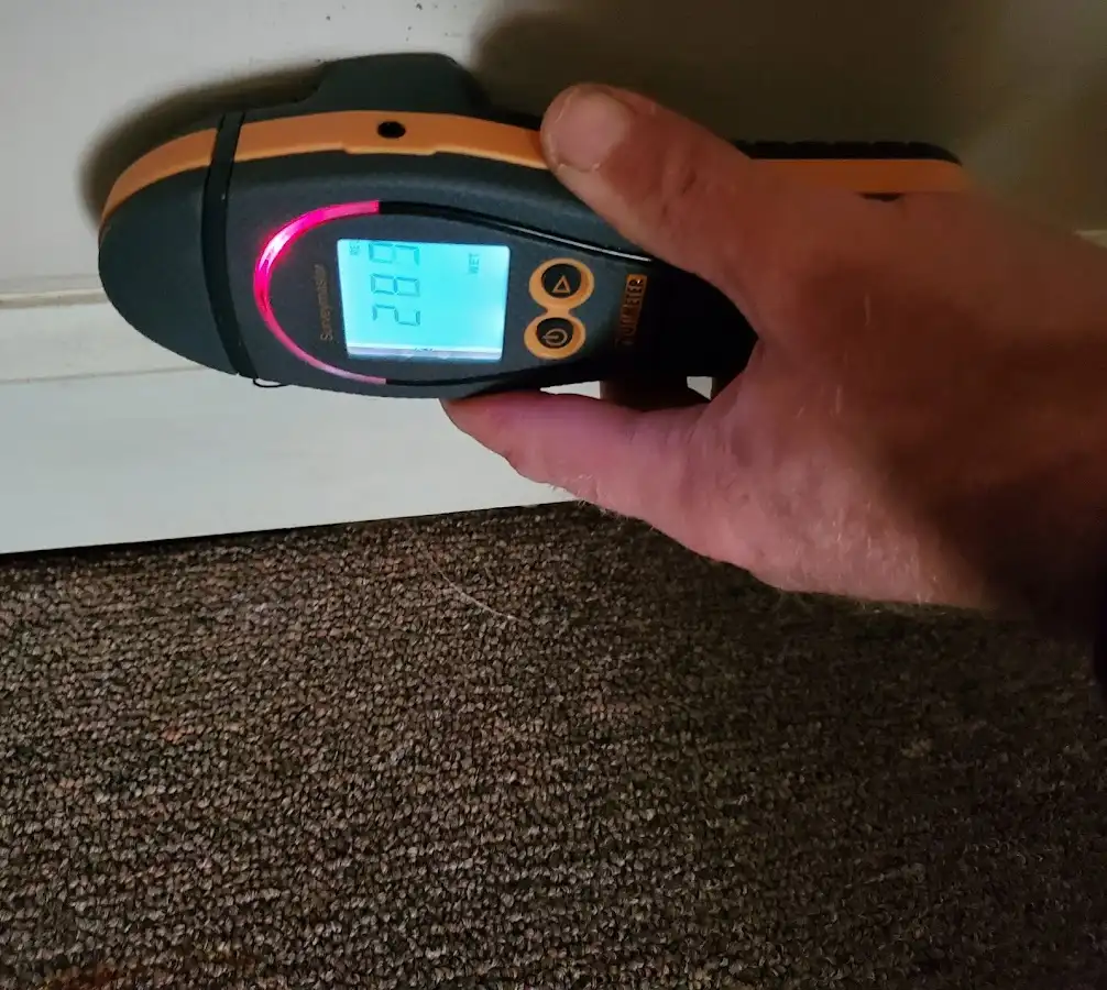 Moisture detection at baseboard during Storm Damage Restoration in Attica